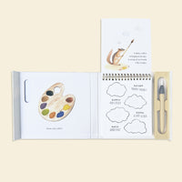 Open book of Wishy Washy Color Reveal with coloring activities and paint palette illustration on a beige background