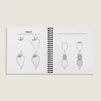 Interior pages of “How to Draw All the Things for Kids” by Alli Koch, showing step-by-step drawing guides in a spiral binding for a strawberry and a pineapple with simple numbered illustrations and fun fruit facts