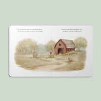 Illustrated book page with a barn and animals on a light green background