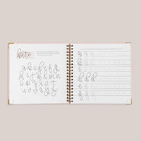 Open view of 'Modern Calligraphy' with calligraphy practice pages on a beige background