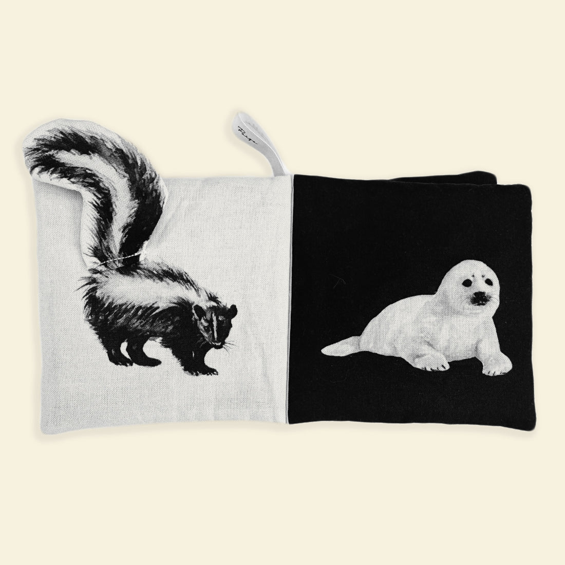 Book with pages showing a skunk on one side and a seal on the other, on a white background.