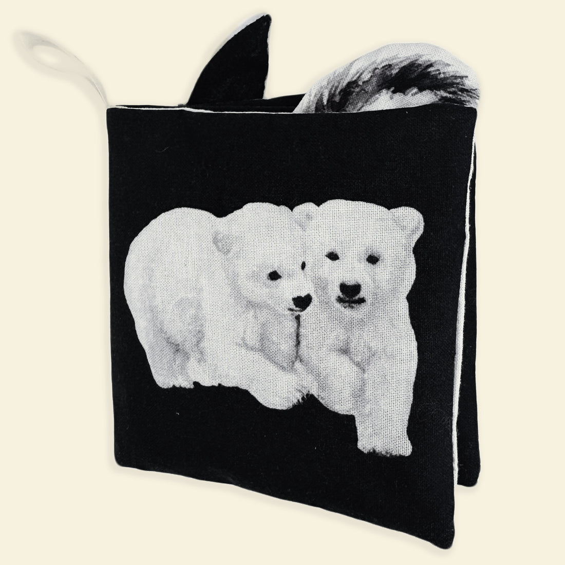 Black soft touch book with white polar bear design on a beige background