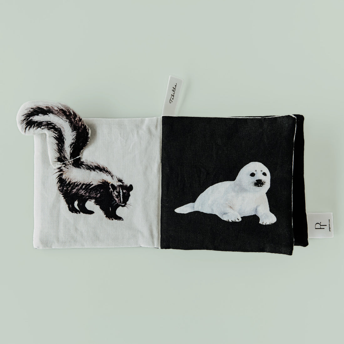 Two fabric pouches with animal illustrations on a light green background