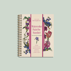 A spiral-bound art book titled 'Watercolor Paint-by-Number: The Painted Garden' by Sarah Connor, featuring a cream cover with pink text and pink vertical stripes, decorated with watercolor illustrations of flowers and berries. The book is centered on a solid sage green background.