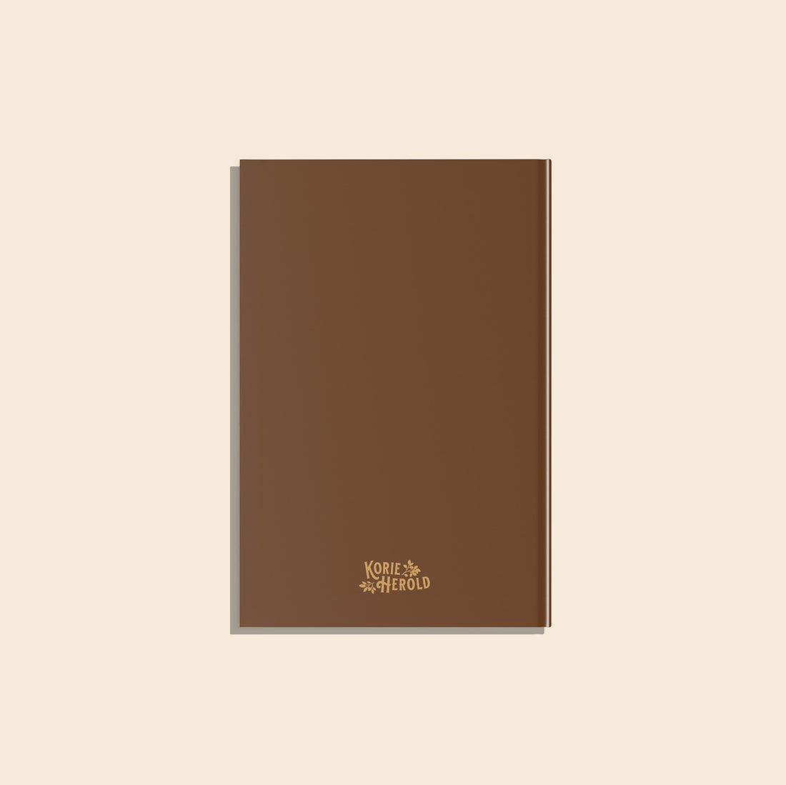 Brown notebook with a brand logo on a beige background