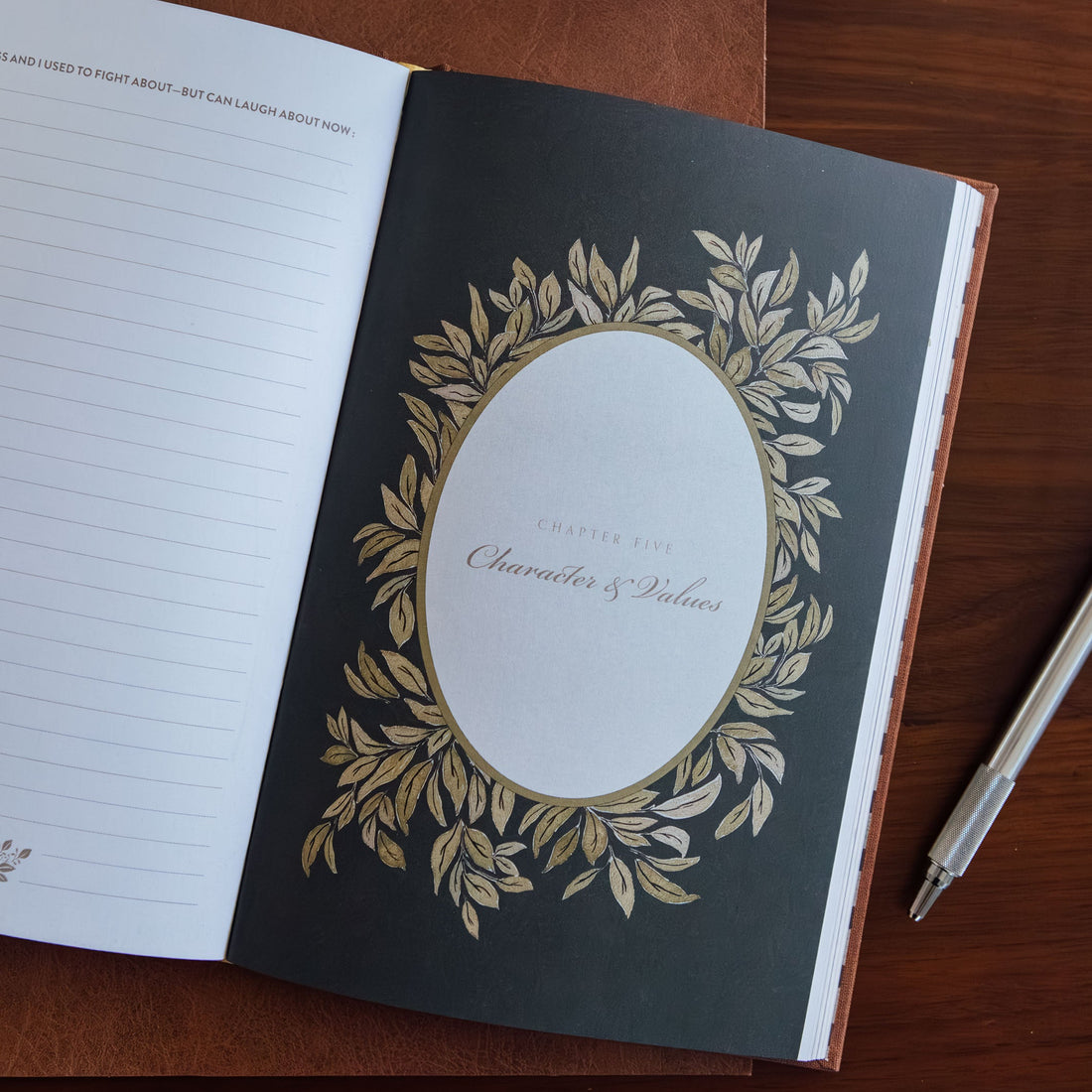 Open notebook with decorative cover on a wooden surface
