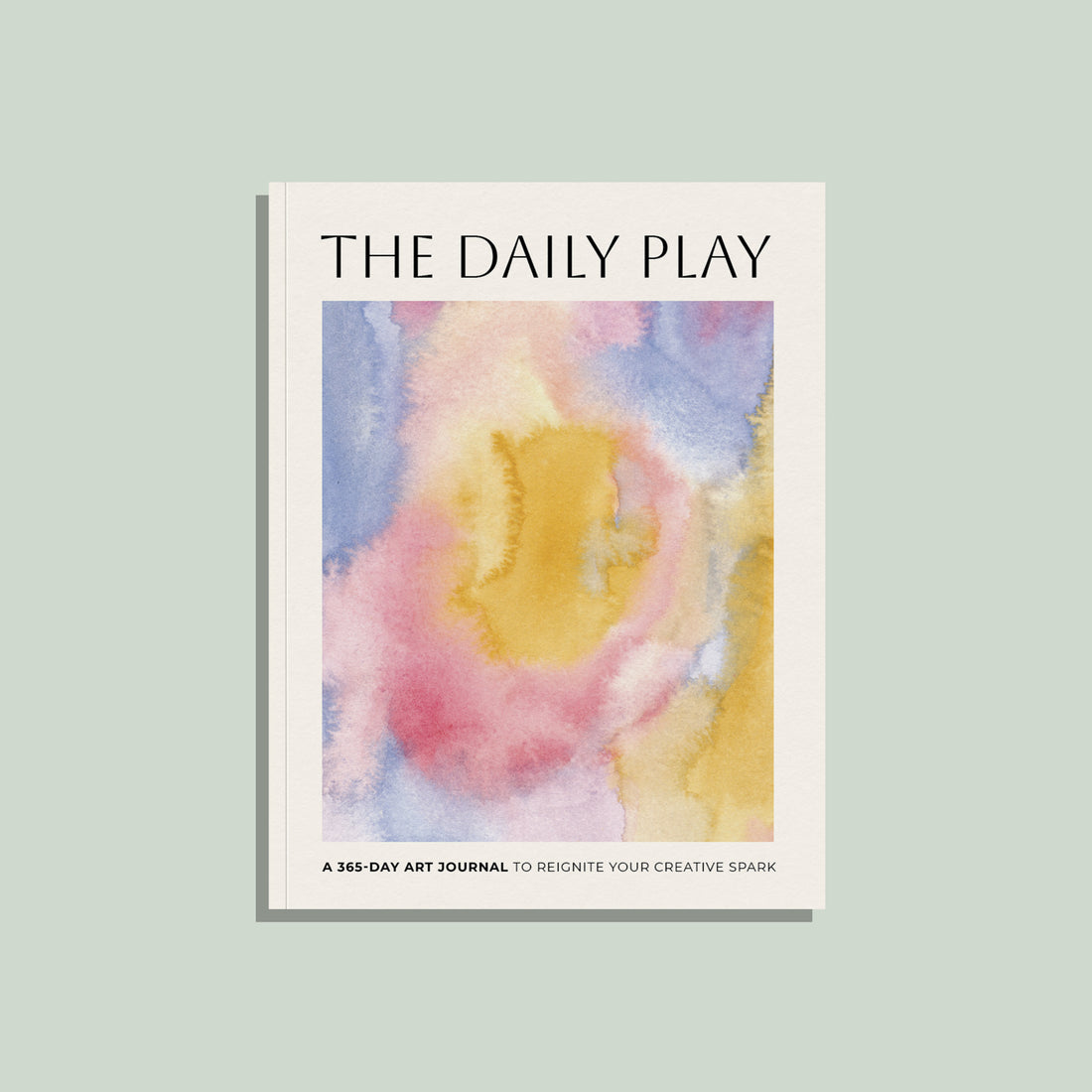 Book titled 'The Daily Play' with a watercolor cover on a light green background