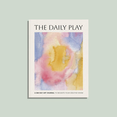 Book titled 'The Daily Play' with a watercolor cover on a light green background