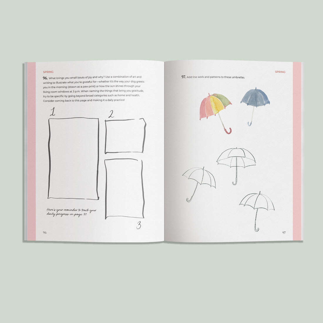 Open book showing illustrations of umbrellas and drawing guides on a light green background