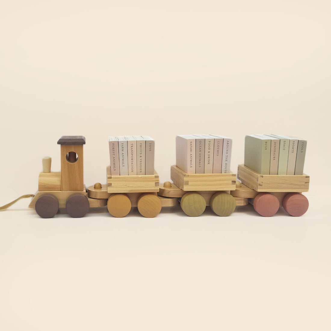 Wooden toy train with three cargo boxes on a beige background