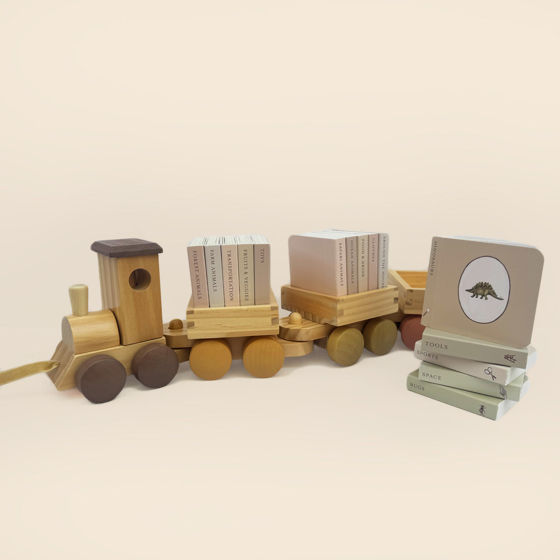 Wooden toy train with books on a beige background