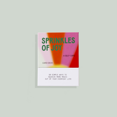Cover of 'Sprinkles of Joy' shows a gradient of pink, orange, and reds in a sun shine pattern. 